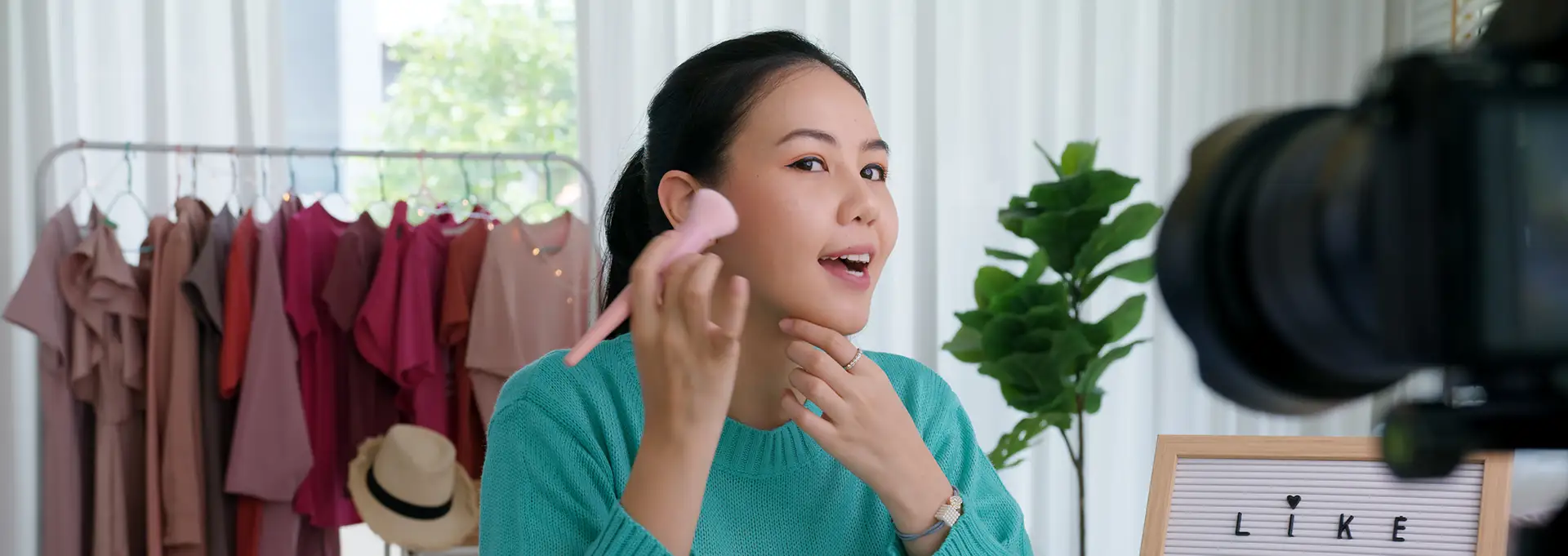 Asian woman shooting viral makeup video.