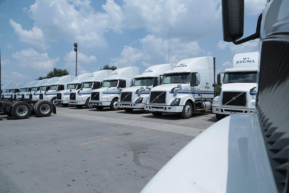 Photography of Sygma trucks in a line.