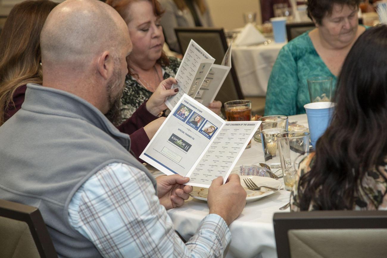 attendees at a table looking at the event program