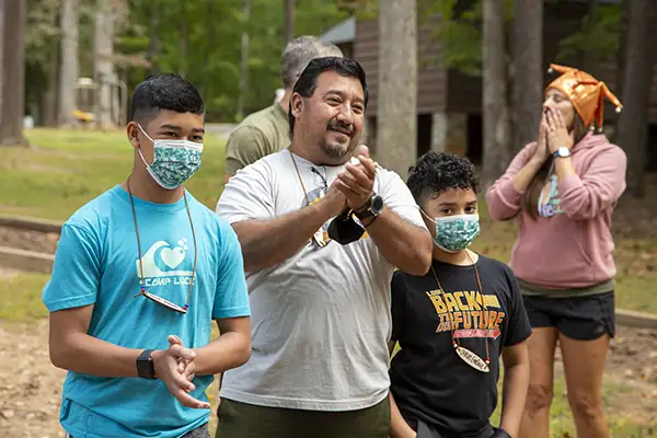 Father and two sons participate in camp activities.
