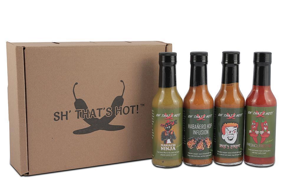 Product shot of Sh' That's Hot hot sauce collection.