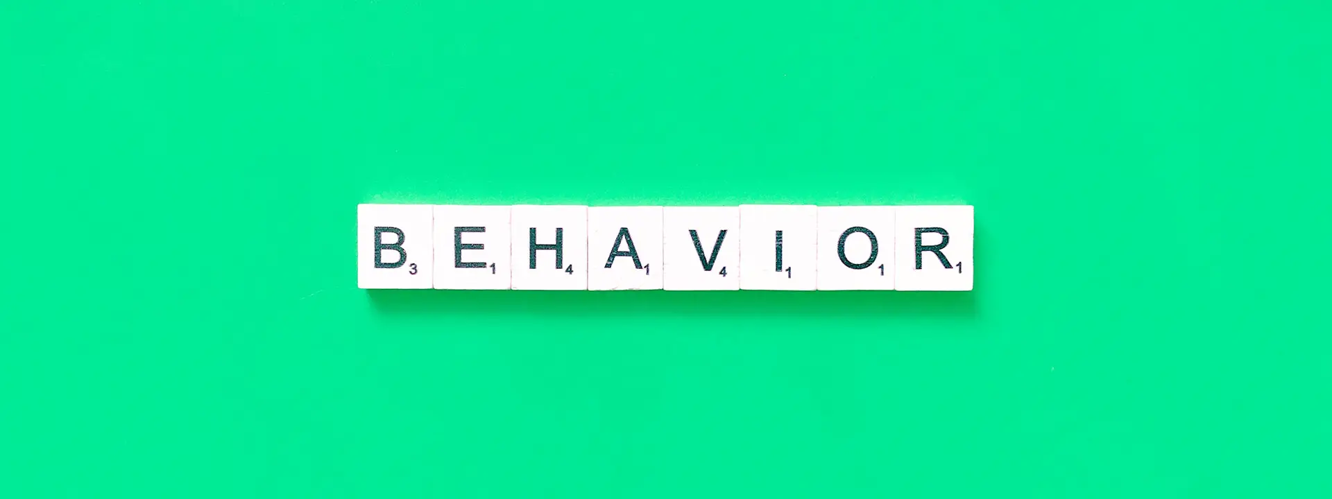 Green background with the word behavior.