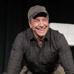 Mike Rowe speaking at an event in California