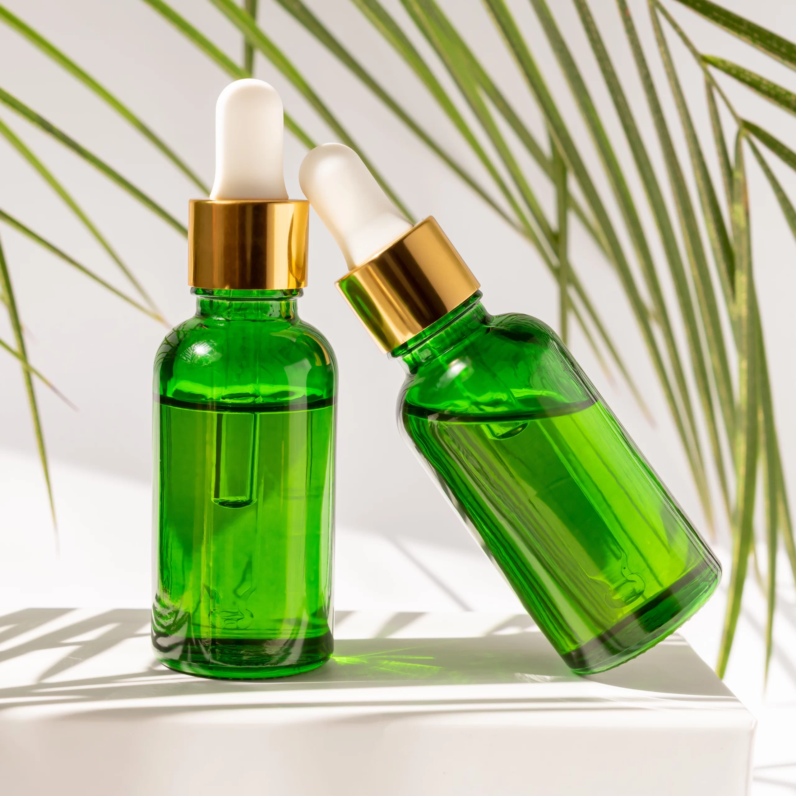 Two green bottles of essential oils.