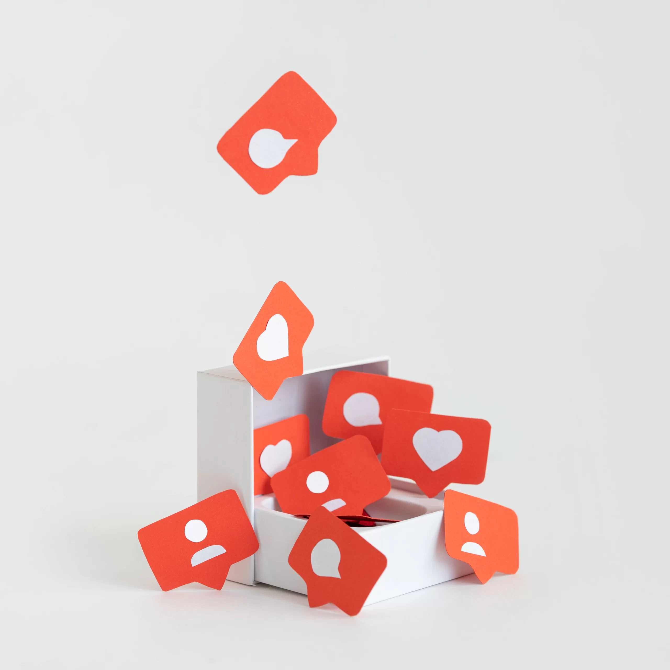 Group of red paper question marks and hearts.